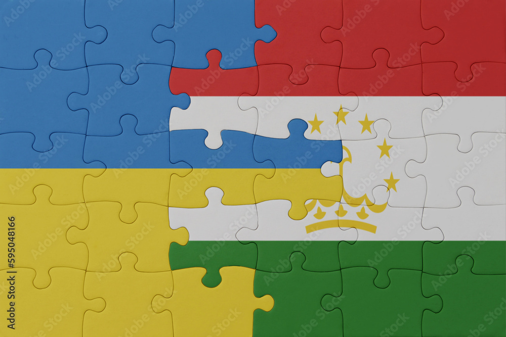 puzzle with the national flag of ukraine and tajikistan . macro.concept. puzzle with the national flag of ukraine and tajikistan . macro.concept.