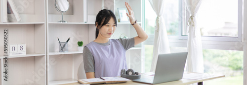 Young Asian women are greeting friends and teachers through video chats and greeting them with cheerful expressions, Online communication , Stay home, New normal, VDO Call, Internet learning.