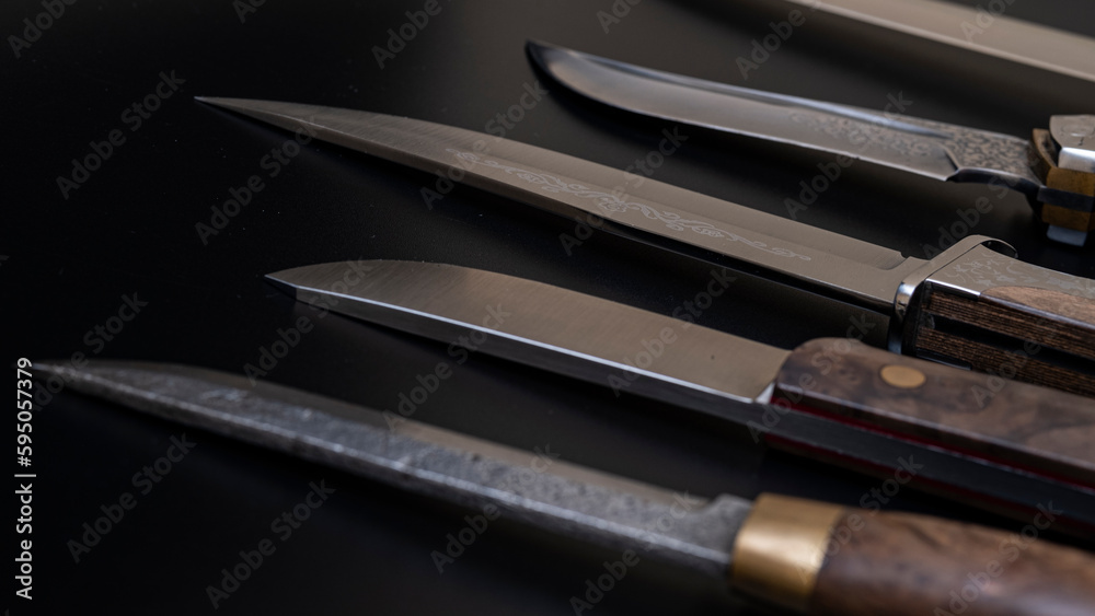 Damascus steel knives on a black background. Kitchen knives. background with japanese knife. A set of Japanese Damascus steel knives. Banner Damascus steel knives on a black background. Kitchen knives. background with japanese knife. A set of Japanese Damascus steel knives. Banner