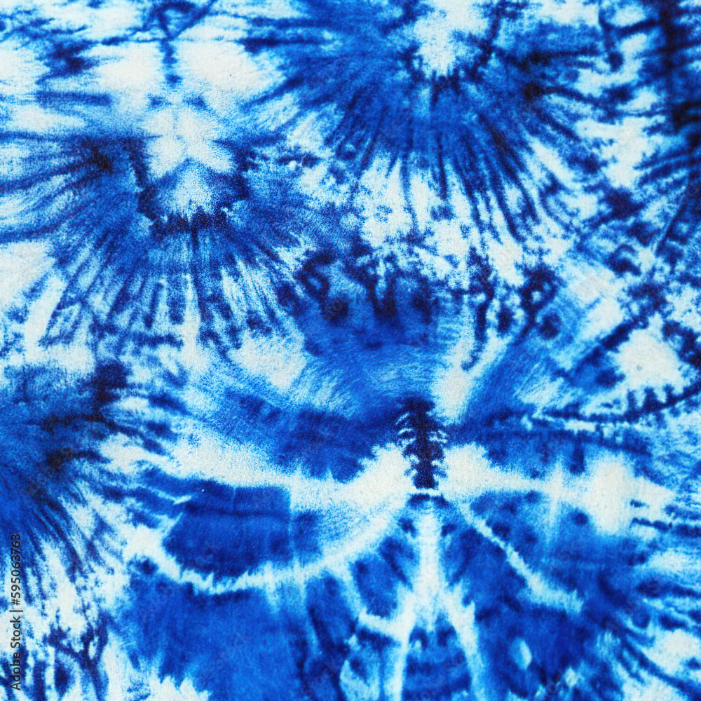Indigo blue shibori tie dye background. Japanese style batik textile. Variegated for summer fashion swatch. Indigo blue shibori tie dye background. Japanese style batik textile. Variegated for summer fashion swatch.