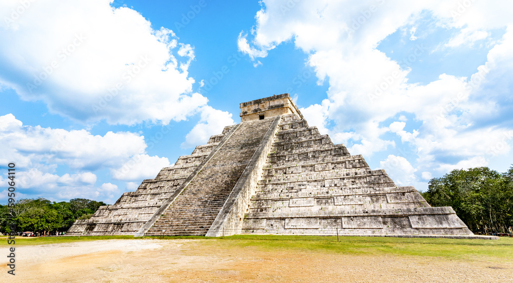 Wide from view of El Castillo landmark also knwn as Temple of Kukulcan at Chichen Itza structure site in Yucatan Mexico - Travel concept with one of new seven wonder of the world - Bright vivid filter
