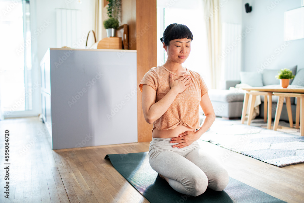 Young Japanese woman doing yoga at home Young Japanese woman doing yoga at home