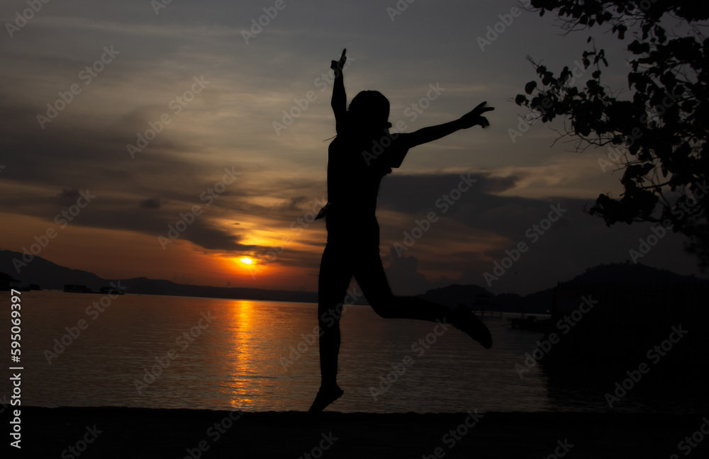 jumping on the beach during sunrise