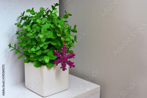 Vase with green flowers. purple snowflake