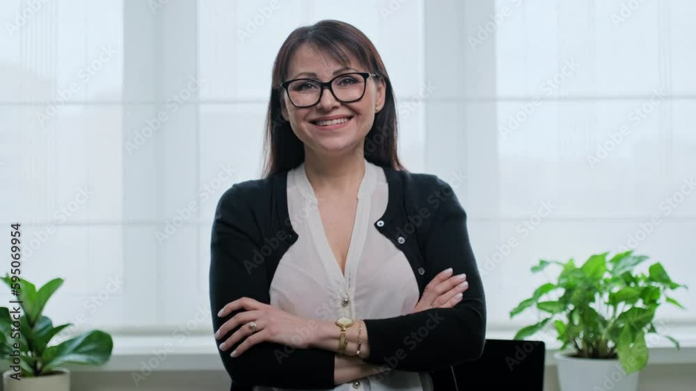 Portrait of confident mature woman in front of home office