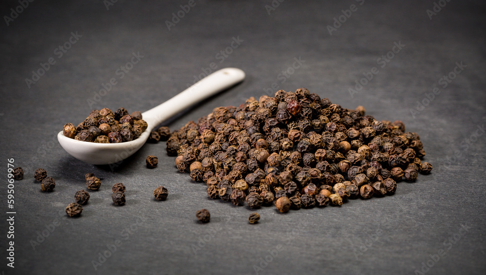 Dry ground black pepper corn spices for recipes. Spoon and a pile of hot powder pepper. Ground spice Dry ground black pepper corn spices for recipes. Spoon and a pile of hot powder pepper. Ground spice