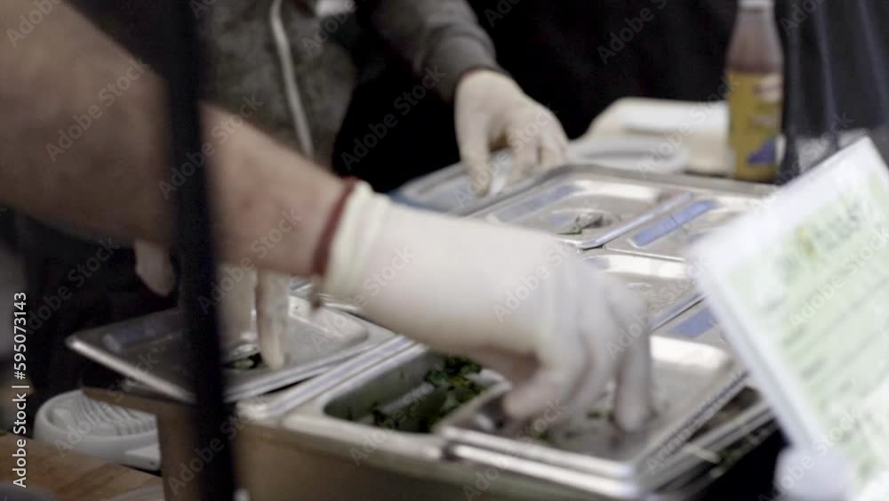 Closeup of the chefs in a restaurant's kitchen preparing the ingredient of the fast food Closeup of the chefs in a restaurant's kitchen preparing the ingredient of the fast food