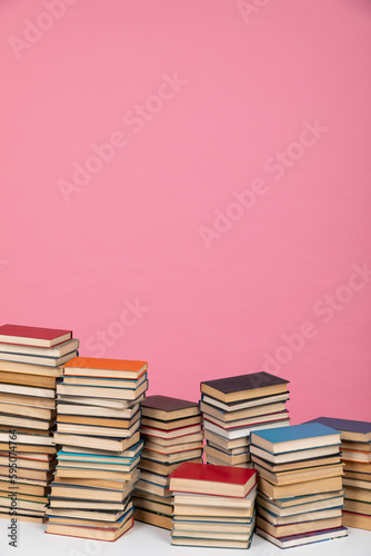 stack of books on a pink background in the learning library