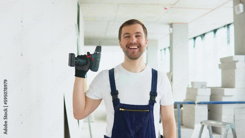 Drywall worker prepares a screwdriver for work Drywall worker prepares a screwdriver for work