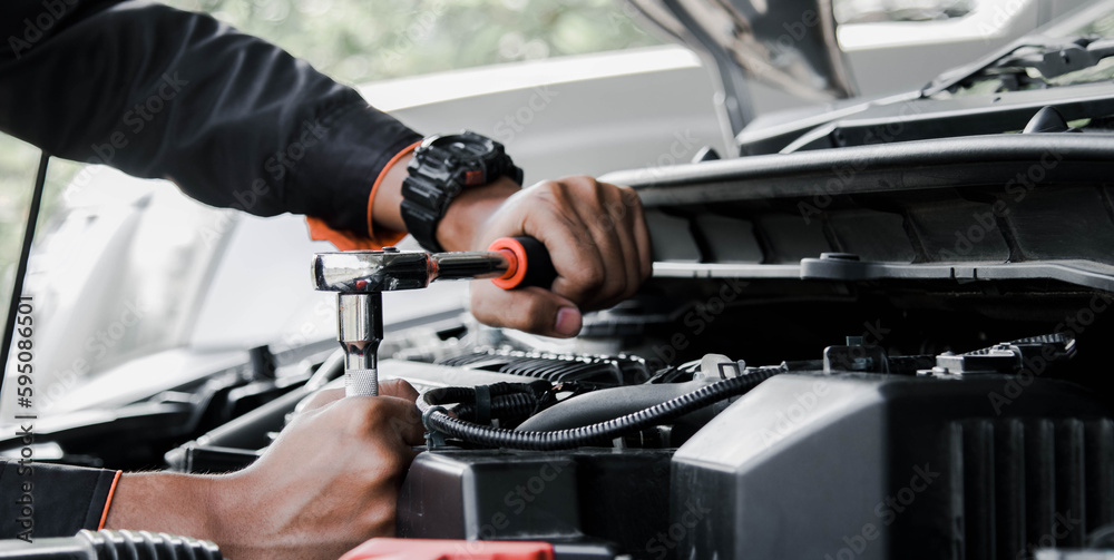 Mechanic fixing a car at home. Repair and service. Mechanic fixing a car at home. Repair and service.