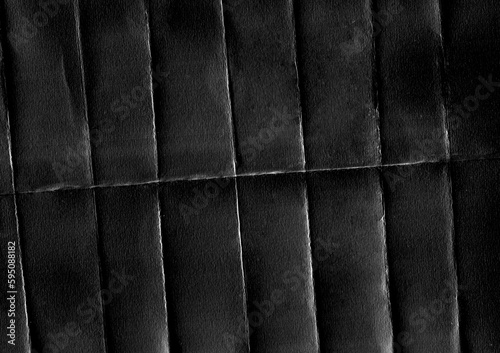 Black paper with scuffs and oblique fold lines