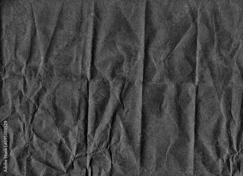Dark gray crumpled paper with texture of noise, scratches, dust