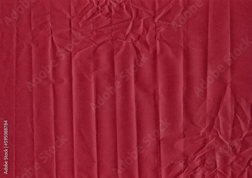 Horizontal wrinkled folds on burgundy paper with tears