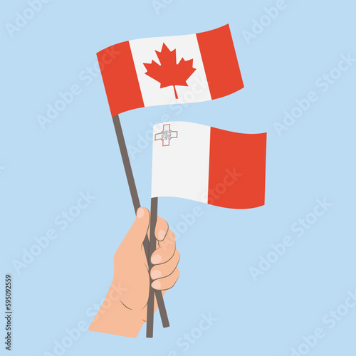 Flags of Canada and Malta, Hand Holding flags © Настасья Стось