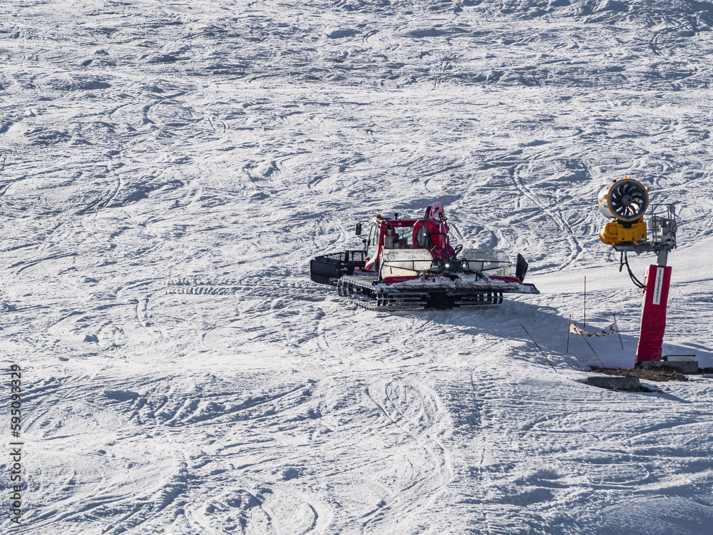 Snowcat, ratrack - machine for snow preparation while working in Alpe D'huez - One of the most popular ski resorts in the Alps in France Snowcat, ratrack - machine for snow preparation while working in Alpe D'huez - One of the most popular ski resorts in the Alps in France