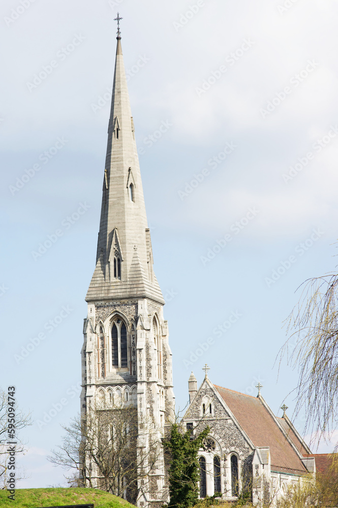 Tower of Saint Albans church in Copenhagen in Denmark with a cloudy sky