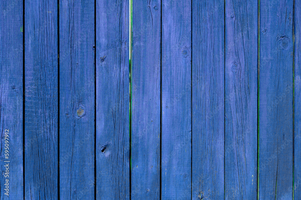 wooden fence made of boards, painted blue