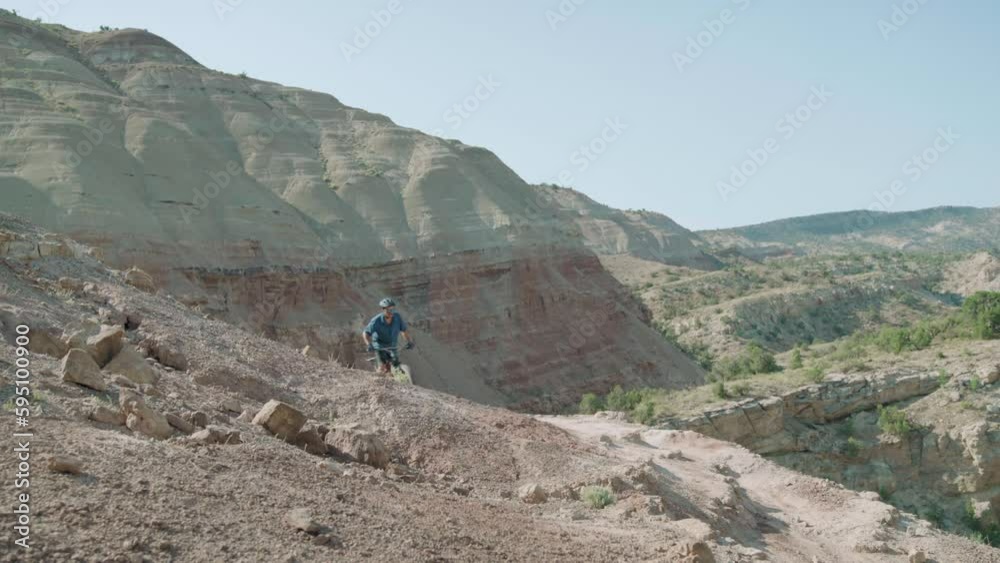 Man mountain biking in the desert on the Utah and Colorado border, USA Man mountain biking in the desert on the Utah and Colorado border, USA