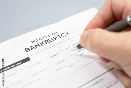 Hand filling a Bankruptcy form