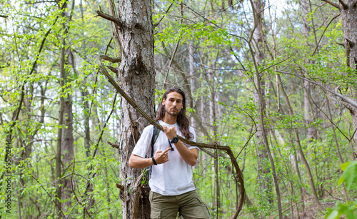 Long hair man in forest photo