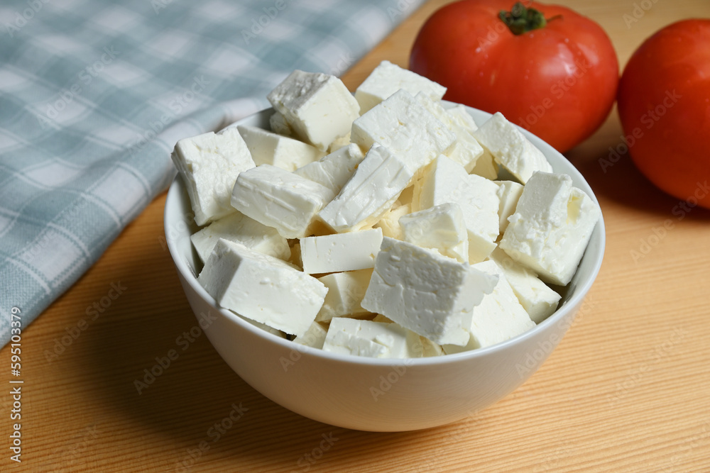 bowl of feta cheese cubes on table closeup