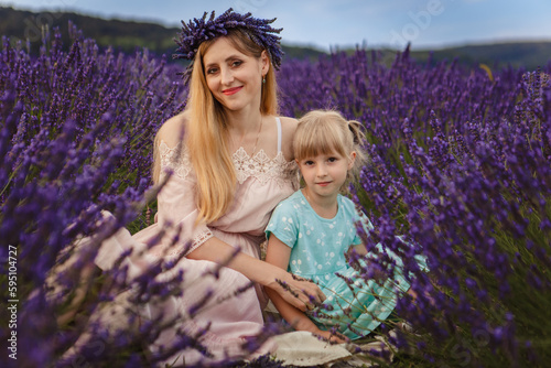 mom hugs her daughter. family picnic on a lavender field