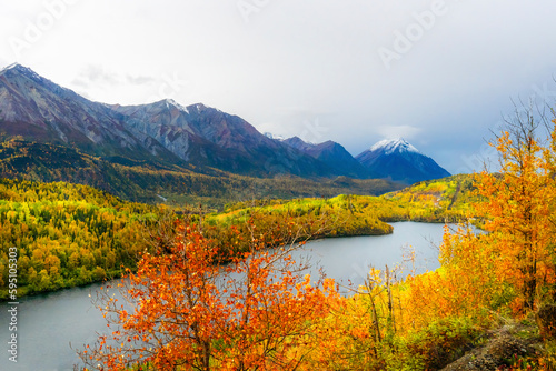 Alaska  Highway 1. Fall landscape with river and snow-capped volcano.