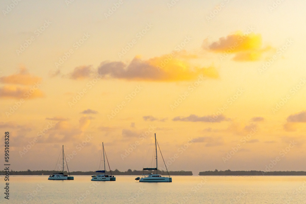 French Polynesia, Taha'a. Anchored sailboats at sunrise.
