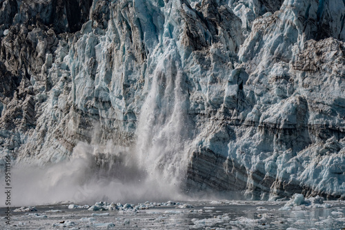Ice crumbles with a loud roar from the terminus of Johns Hopkins Glacier.