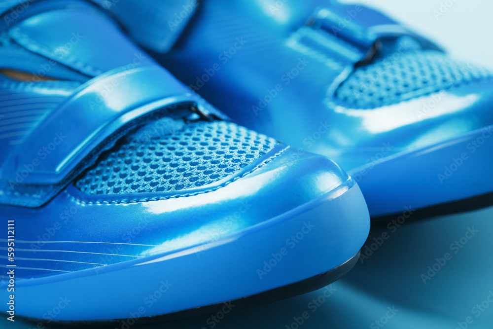 Blue bicycle shoes on a blue background Blue bicycle shoes on a blue background