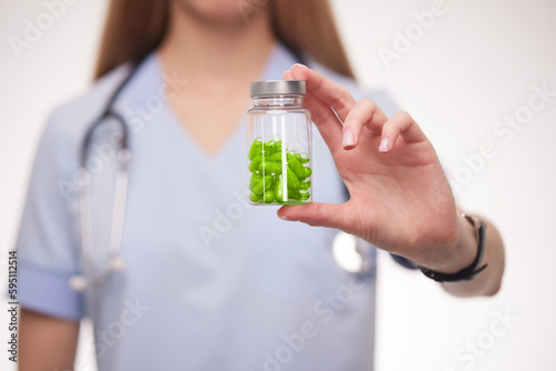 doctor holding a bottle of pills in his hands close-up