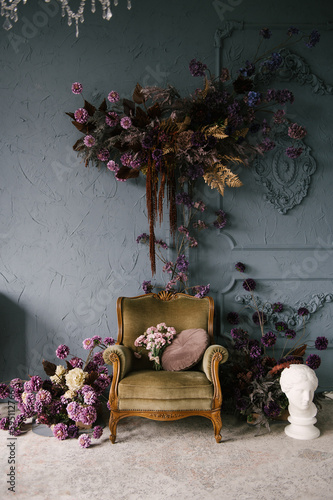 Obraz na płótnie Vintage wooden armchair decorated with flower arrangements in the interior, luxury home design w salonie