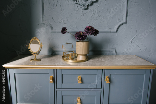 Obraz na płótnie Vintage chest of drawers decorated with flowers in the interior with stucco on the wall, luxury home design w salonie