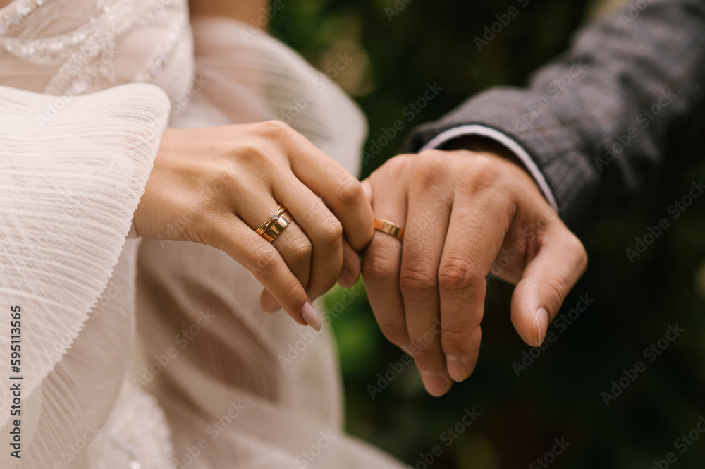 The bride and groom hold hands