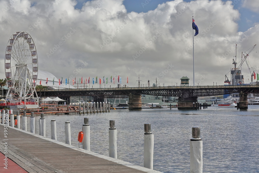 The cyclist and pedestrian Pyrmont Bridge across Cockle Bay-Darling Harbour ferris wheel at left. Sydney-Australia-603