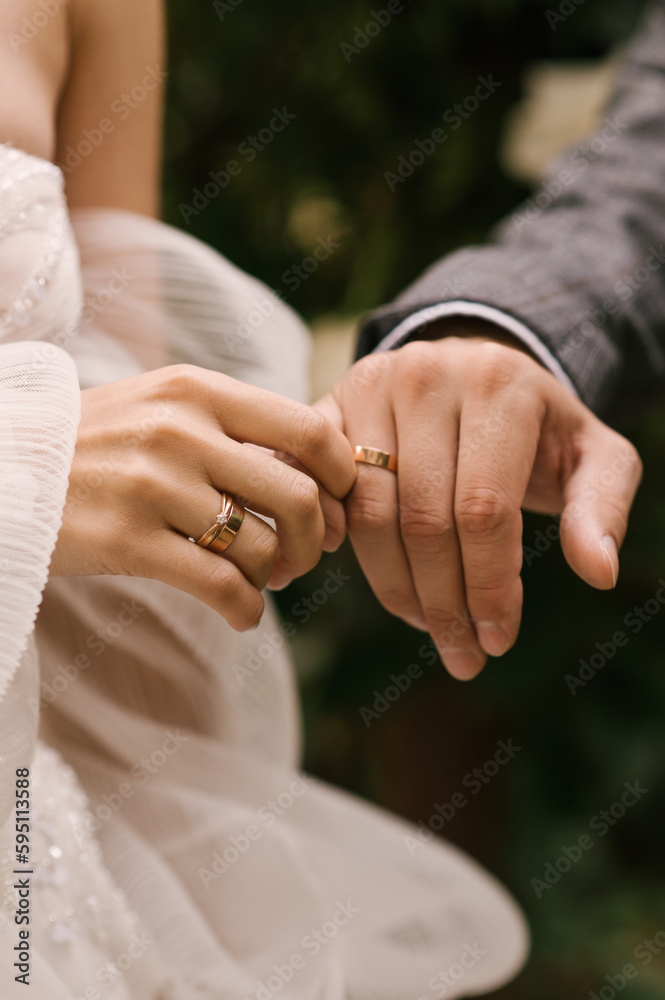 The bride and groom hold hands