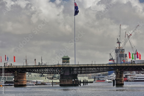 The cyclist and pedestrian Pyrmont Bridge across Cockle Bay-Darling Harbour-huge national flag. Sydney-Australia-602 photo