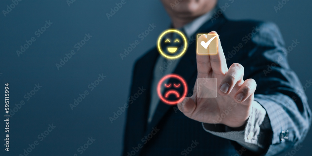 a businessman touching the virtual screen on the happy smile face icon to give satisfaction in service.rating very impressed.customer review service and Satisfaction concept a businessman touching the virtual screen on the happy smile face icon to give satisfaction in service.rating very impressed.customer review service and Satisfaction concept
