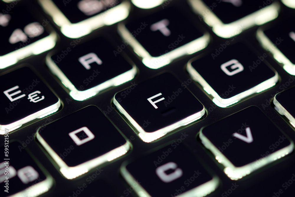 Close-up of laptop keyboard illumination, backlit keyboard