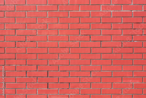 Brick wall painted in pastel pink color as a background