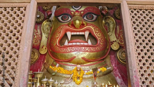 Parallax movement of the historic Mask of Seto Bhairab behind the wooden curtain in Kathmandu Durbar Square, Nepal photo