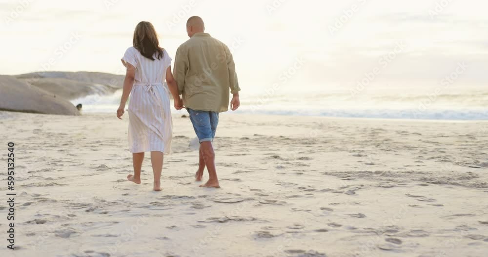 Walking, love and holding hands with couple on beach for romance, bonding and travel at sunset. Relax, holiday trip and summer vacation with man and woman on date for support and commitment Walking, love and holding hands with couple on beach for romance, bonding and travel at sunset. Relax, holiday trip and summer vacation with man and woman on date for support and commitment