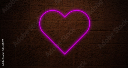 Composition of pink neon heart over brick wall