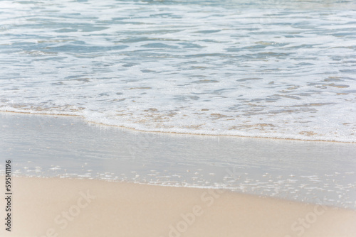 Waves breaking on the shore at the beach