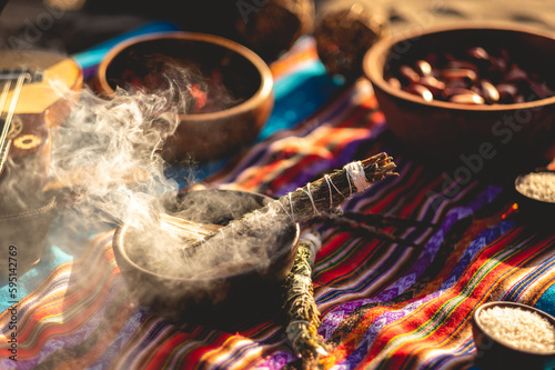Mystical andean journey: peruvian blanket, charango, crystals and burning holy wood incense in the desert sand