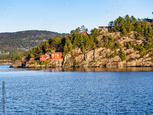 Traditional Norwegian red house on fjord in Eidsvag, Bergen, Norway