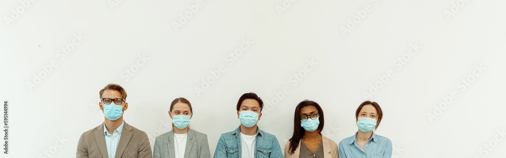 Colleagues in face masks sitting on chairs