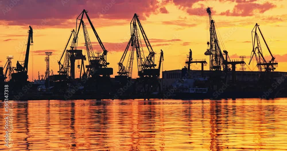 Sea port with working industrial cranes during scenic sunset, trading harbor and ripple water 4k video Sea port with working industrial cranes during scenic sunset, trading harbor and ripple water 4k video