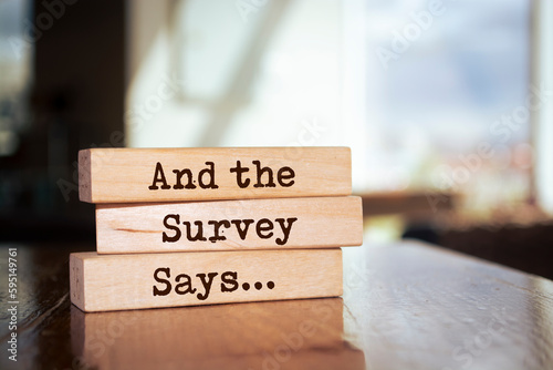 Wooden blocks with words 'And the Survey Says...'.