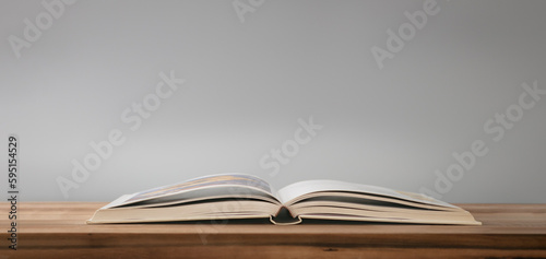 Open book on the table on wood surface. Learn concept.